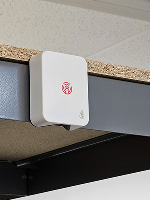 The image depicts the Room Alert MAX Temperature & Humidity Sensor mounted on a ceiling.